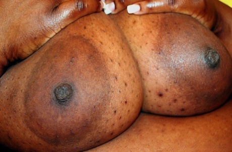 Ebony SSBBW Ms Alotoftitties sets her massive titties loose on a chair