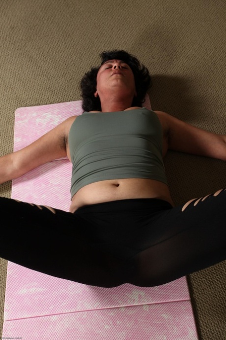 Mature woman Desiree strips after her yoga session & spreads her hairy crotch