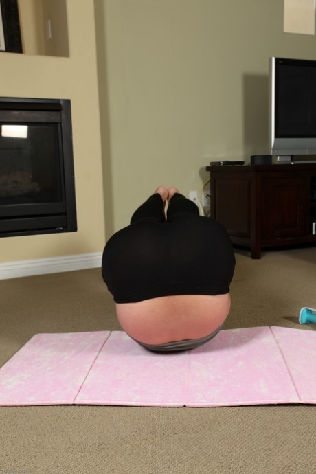 Mature woman Desiree strips after her yoga session & spreads her hairy crotch